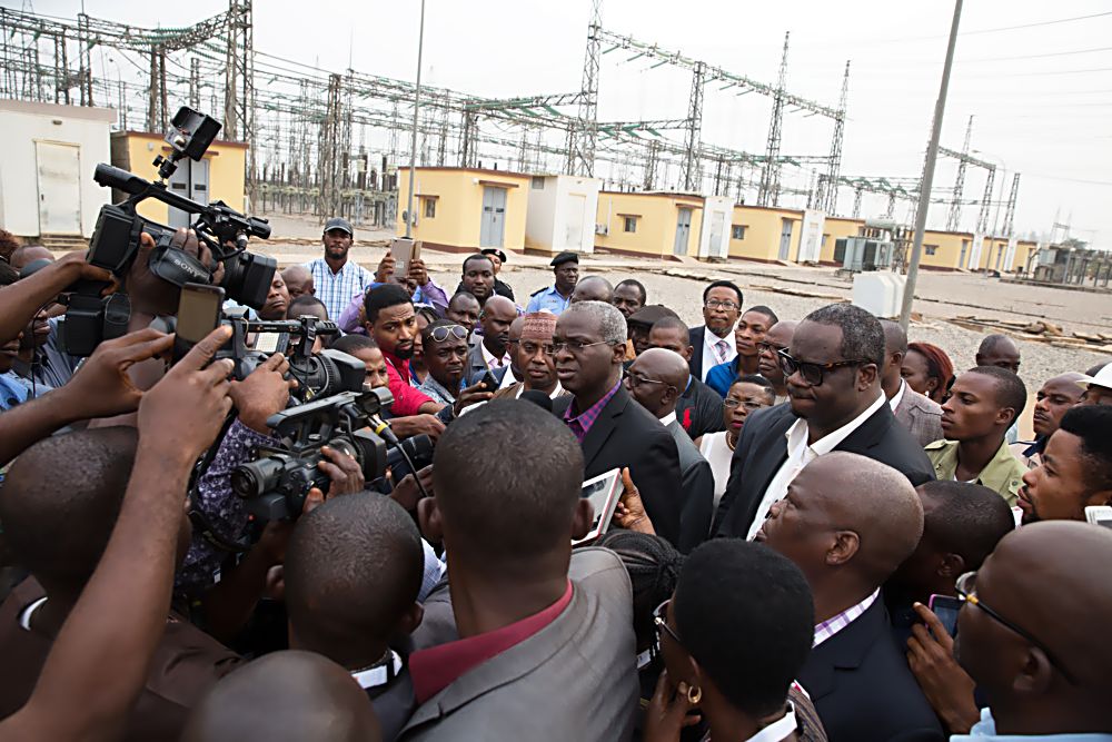 Hon. Minister of Power, Works & Housing, Mr Babatunde Fashola, SAN (middle) speaking with Journalists shortly after inspecting the TCN Ikeja West 330/132 KV Transmission Station after the Eleventh Monthly Meeting with Operators in the Power Sector at the  TCN Ikeja West Transmission Station, Ayobo, Ipaja,Lagos State on Monday  9th, January 2016.  With him are Managing Director of the Transmission Company of Nigeria, Engr. Abubakar Atiku(left)and Chairman, Egbin Power Plc, Mr Kola Adesina(right)