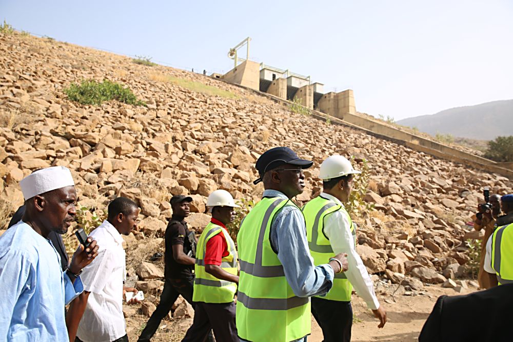 Hon Minister of Power Works  Housing Mr Babatunde Fashola SAN middle being conducted round by the  Mabon Representative Mr Christopherright during the HonMinister s inspection tour of the 40MW Hydro Power Plant in Dadin Kowa Gombe State State on Day Three of his inspection tour of Highway Projects in the North East Zone on Saturday 18th March 2017