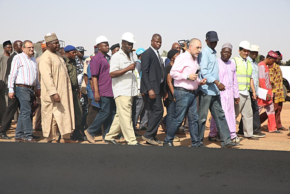 Hon Minister of Power Works  Housing Mr Babatunde FasholaSANright being briefed by the Managing Director Messrs Mothercat Nigeria Limited Jack ElNajjarmiddle and others during the Hon Ministers inspection tour of the ongoing construction work on the  Potiskum Bypass which is part of the Dualisation of Kano Maiduguri Road Section III in Yobe State on Saturday 18th March 2017