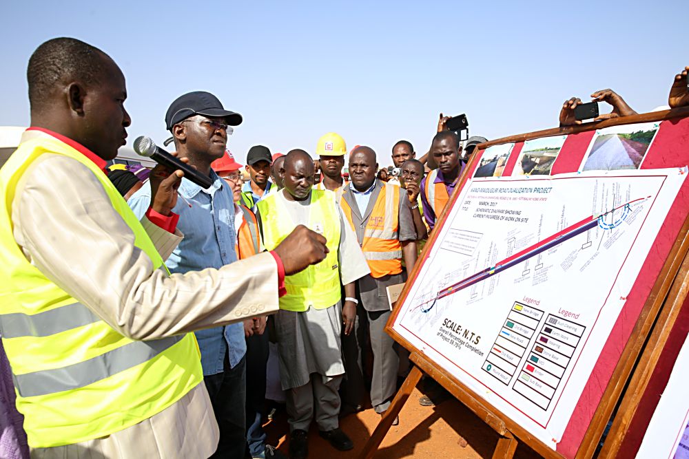 Hon Minister of Power Works  Housing Mr Babatunde FasholaSAN2nd left being briefed by the Federal Controller of Works Yobe State Engr Olusegun Akinmadeleft Area Manager CGC Mr Wen Hai Mingmiddle Engr Bala Rogo2nd right and others during the Hon Ministers inspection tour of the Dualization of KanoMaiduguri Road Section  IV Potiskum  Damaturu in Yobe State  on Saturday 18th March 2017