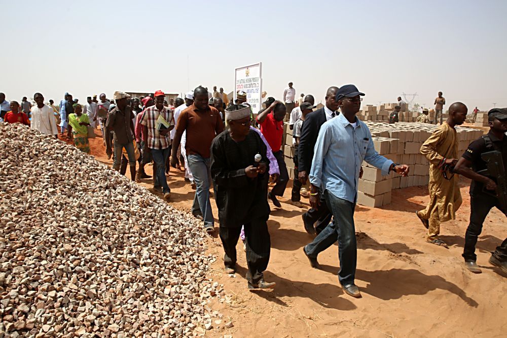 Hon Minister of Power Works  Housing Mr Babatunde Fashola SAN right being briefed by the Federal Controller of Housing Taraba State TLP Pius Eneji right  during the HonMinister s inspection tour of the National Housing Programme site of the Federal Government in Gombe State on Day Three of his inspection tour of Highway Projects in the North East Zone on Saturday 18th March 2017