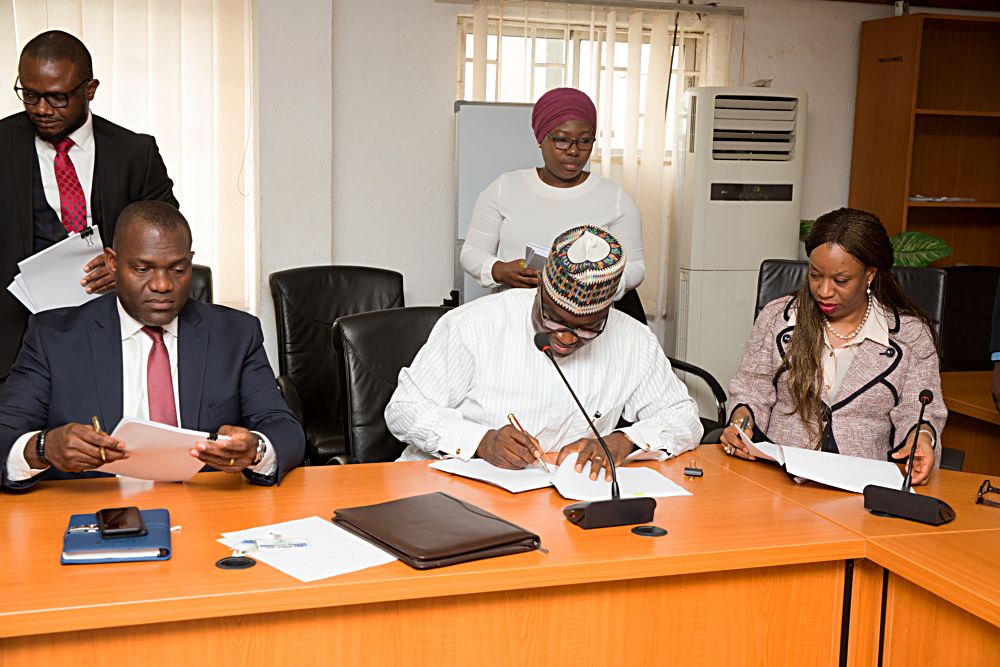 Managing DirectorCEO Nigerian Bulk Electricity Trading Plc NBET Dr Marilyn Amobi right Chief Executive Officer Afrinergia Power Ltd Mr Matthew Igblajobimiddleand  Chairman Afrinergia Power Ltd Mr Bestman Uwadia left during the signing ceremony of the PutCall Option Agreement POCA for Afrinergia and CT Cosmos Solar Power Developers by the Federal Government at the Ministry of Power Works and Housing Headquarters Mabushi Abuja on Tuesday 11 April 2017