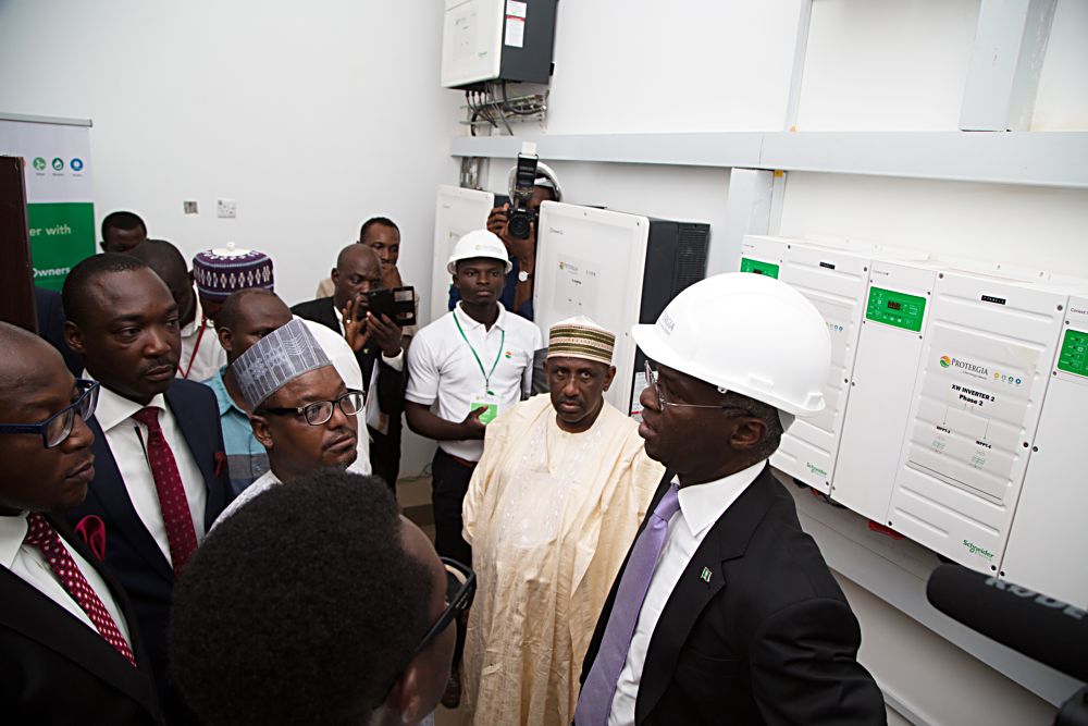 Hon Minister of Power Works  Housing Mr Babatunde Fashola SANright Ag Permanent Secretary to the Ministry  Alh Chubado Muhammad Jada right and others during  the Inspection tour of the Control room at the Commissioning of the 100kWP RoofTop Solar PV System at the House on the Rock Abuja on Tuesday 23 May 2017