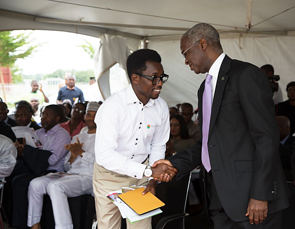 Hon Minister of Power Works  Housing Mr Babatunde Fashola SANright being welcomed by the Chief Executive Officer Protergia Mr Ayodeji Dejileft to  the  Commissioning of the 100kWP RoofTop Solar PV System at the House on the Rock The RefugeCitadel  Towers City Gate Abuja on Tuesday 23 May 2017