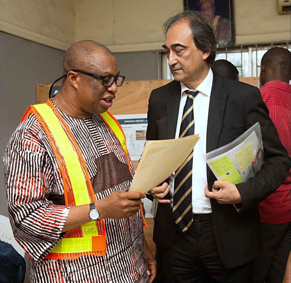 Director Highways Construction and Rehabilitation in the Ministry of Power Works and Housing Engr Yemi Oguntominiyi left presenting the Engineers Order to the Managing Director AG  Dangote Construction Company Limited Mr Ashif Juma right during a press briefing on the Kick Off of the Reconstruction of the 2km long Apapa Wharf Dual Carriageway in Lagos State on Saturday 17th June 2017