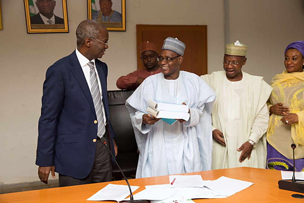 Hon Minister of Power Works  Housing Mr Babatunde Fashola SANleft Permanent Secretary Works  Housing Mr Muhammed Bukar 2ndleftDirector and HOD Public Building and Housing Development Department Arc Sani Gidado2ndright and Director in the Department  Mrs Salma Mohammedright during the presentation of the Summary of the 2017 Revised Edition of the National Building Code to the Hon Minister at the Ministry of Power Works  Housing Headquarters Mabushi Abuja on Tuesday 11th July 2017