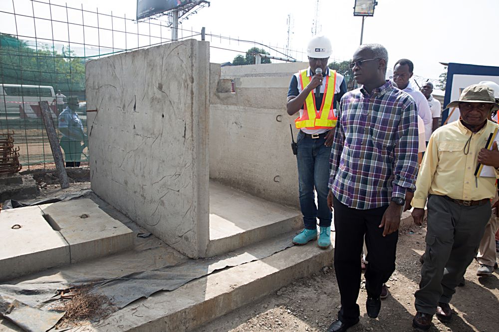 Hon Minister of Power Works  HousingMr Babatunde FasholaSANmiddle Federal Controller of Works Lagos State Engr Godwin Eke right and Project Manager AG Dangote Construction CompanyEngr Tunde Jimoh middle inspecting the precast side drain during an inspection tour of the ongoing reconstruction of Wharf Road Apapa in Lagos on Saturday 2nd September  2017