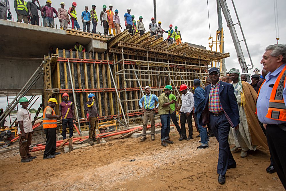 Hon Minister of Power Works and Housing Mr Babatunde Fashola SAN left and Chief Engineer Reynolds Construction Nigeria Limited Mr Igor Zauodtchikright during the Hon Ministers joint inspection of the ongoing construction of Loko Oweto Bridge over River Benue in Nasarawa and Benue States with hisAgriculture and Rural Development counterpart Chief Audu Ogbehon Tuesday 26th September 2017