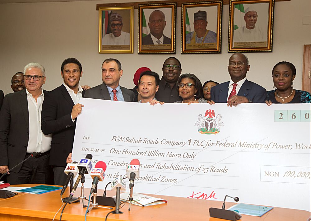 Hon Minister of Power Works  HousingMr Babatunde FasholaSAN2nd rightMinister of Finance Mrs Kemi Adeosunright Minister of State HonMustapha Baba Shehuri4th right Director GeneralDebt Management Office Mrs Patience Oniha3rd right Managing Director RCC EngrMoussa Nakhla and other contractorsduring the presentation of the cheque of the N100Billion Sukuk Issuance Proceed by the Minister of Finance to the Minister of PowerWorks and Housingat the Ministrys Headquarters Mabushi Abuja on Thursday 5thOctober 2017