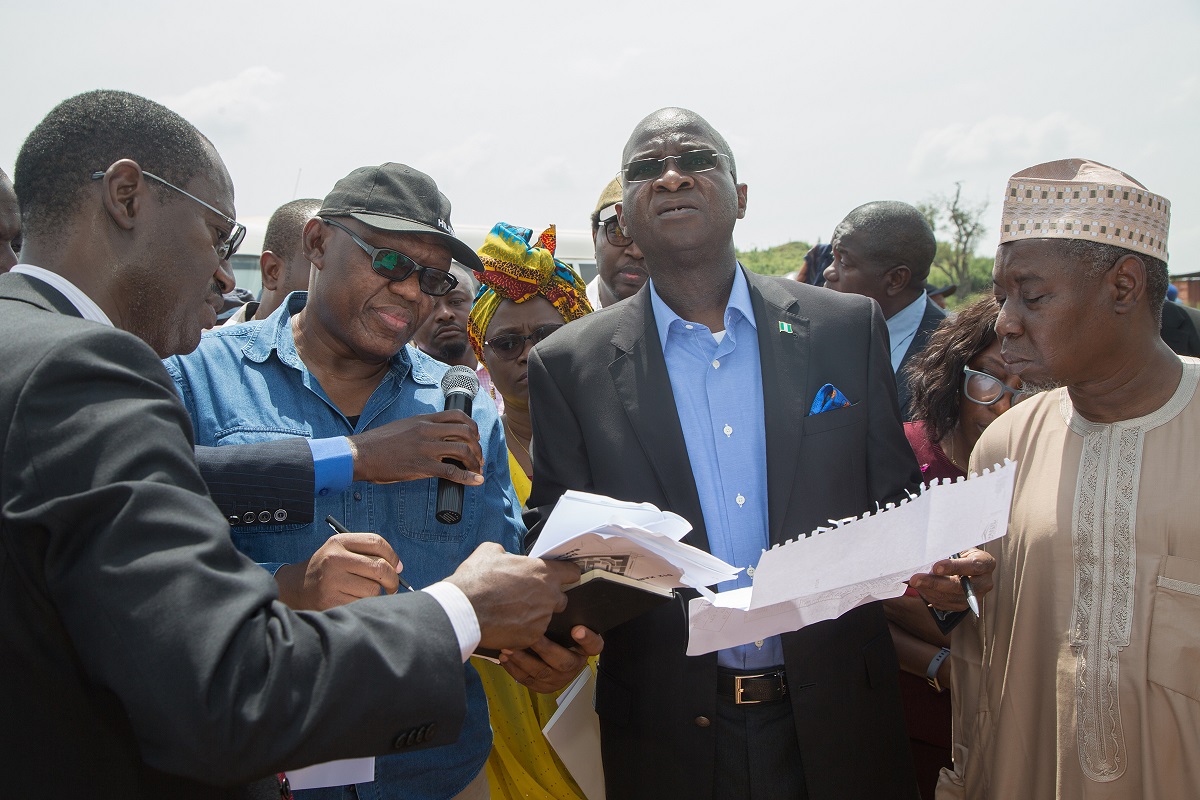  Hon Minister of Power Works  Housing Mr Babatunde Fashola SAN right Minister of State Hon Mustapha Baba Shehuri left Surv Suleiman Zarma Hassan 2nd right Managing DirectorCEO Federal Mortgage Bank of NigeriaFMBN Arc Ahmed Dangiwa left and Executive Director Associated Design Consultants Mr Uche Ezenwaka 2nd left during the inspection of the FMBN Goodluck Jonathan Legacy City Housing Project in Kara District Abuja