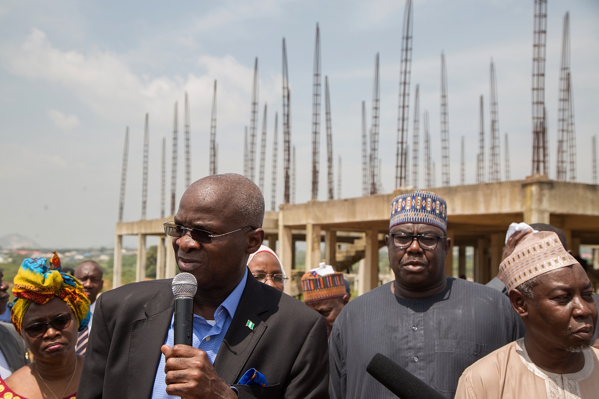 Hon Minister of Power Works  Housing Mr Babatunde FasholaSAN 2nd left Minister of State Hon Mustapha Baba Shehuri 2nd rightl Surv Suleiman Zarma Hassan right speaking with journalists shortly after  the inspection of the FMBN Goodluck Jonathan Legacy City Housing Project in Kara District Abuja 