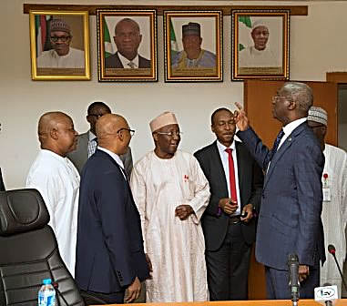 Hon Minister of Power Works  Housing Mr Babatunde Fashola SANrightVice Chairman Nigerian Electricity Regulatory Commission Mr Sanusi Garba middle and others shortly after the presentation of the Eligible Customers Regulatory 2017to the Hon Minister at the Ministry of Power Works  Housing Headquarters Mabushi Abuja on Monday 6th November 2017