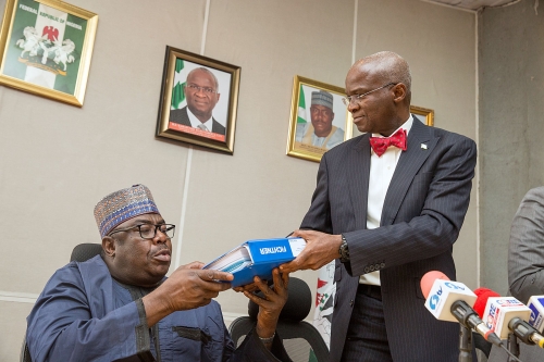 Hon Minister of Power Works  Housing Mr Babatunde FasholaSAN righthands over the Report of the 20 Year Transmission Master Plan to Minister of State Hon Mustapha Baba Shehurileft during the Submission of Report on Consultancy Service on Transmission Expansion Plan Development of Power System Master Plan for TCN  to the Minister at the Auditorium of the Ministry of PowerWorks  Housing Headquarters Power House Maitama AbujaFCT on Tuesday 30th January 2018