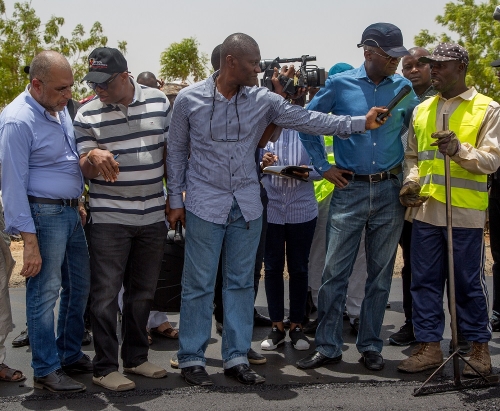 Hon Minister of Power Works  Housing Mr Babatunde Fashola SAN2nd right interacting with aSite Worker with Messrs Mothercat Nigeria LimitedMr Christopher Bulus right With them are Director Highways Construction and Rehabilitation Engr Yemi Oguntominiyi2nd leftManaging Director Mothercat Mr Jack ElNajjar leftDirector  Press in the Ministry Mr Theo Ogeziachi middle and others during the Hon Ministers inspection of the Rehabilitation of Hadejia Nguru Road Phase II  Kirikasama  Nguru in Jigawa Stateon Wednesday 9ththMay 2018