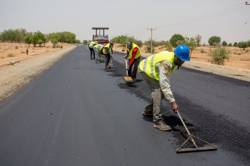 Personnelof Messrs Mothercat Nigeria Limited working during an inspection tour of the Rehabilitation of Hadejia Nguru Road Phase II Kirikasama  Nguru in Jigawa State by theHon Minister of Power Works  Housing Mr Babatunde Fashola SANon Wednesday 9th May 2018