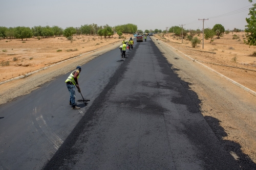 Personnelof Messrs Mothercat Nigeria Limited working during an inspection tour of the Rehabilitation of Hadejia Nguru Road Phase II Kirikasama  Nguru in Jigawa State by theHon Minister of Power Works  Housing Mr Babatunde Fashola SANon Wednesday 9th May 2018