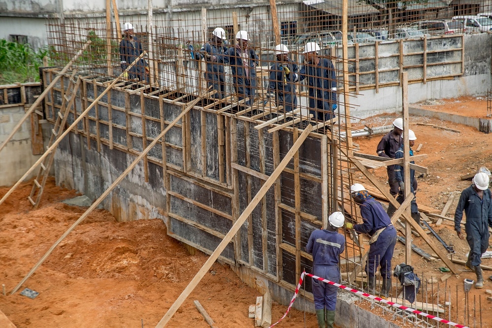 A cross section of the ongoing construction of the IPP Station with personnel at workduring the inspection of the electrifiedshops under the Federal Government s Energizing Economies Initiative by theHon Minister of Power Works  Housing Mr Babatunde FasholaSANatAriar ia Market Aba Abia State on Thursday 17th May 2018