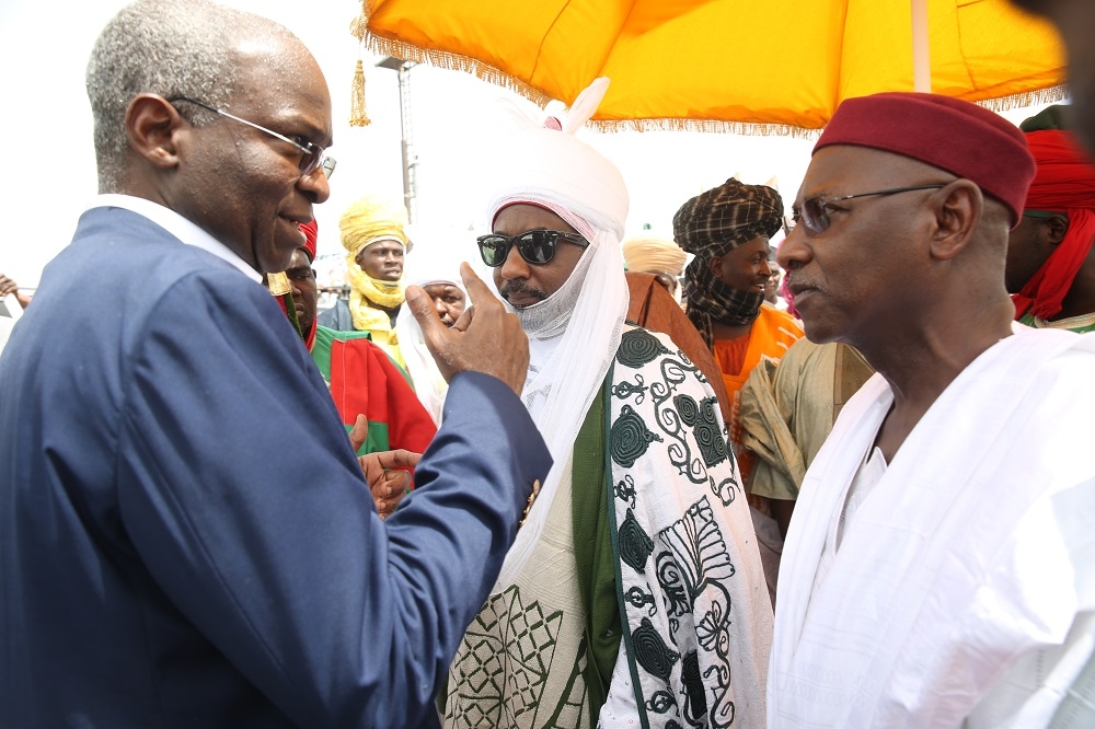 Hon Minister of Power Works  Housing Mr Babatunde FasholaSAN leftDeputy Governor of Kano State Prof Hafizu Abubakar right and Emir of Kano Sanusi Lamido middleduring the flag off of the Reconstruction of the Abuja KadunaZariaKano Dual Carriageway in Chiromawa Toll Plaza Near Kano State on Tuesday 26th June 2018