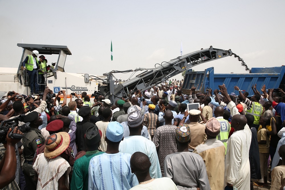 Hon Minister of Power Works  Housing Mr Babatunde FasholaSAN leftsurrounded by Guests and members of the beneficiary communitiesoperates the Milling machine to formally flag off the Reconstruction of the Abuja KadunaZariaKano Dual Carriageway in Chiromawa Toll Plaza Near Kano State on Tuesday 26th June 2018