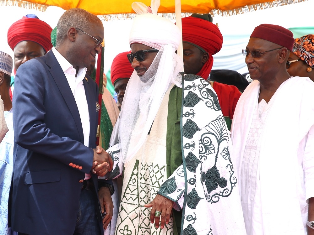 Hon Minister of Power Works  Housing Mr Babatunde FasholaSAN leftDeputy Governor of Kano State Prof Hafizu Abubakar right and Emir of Kano Sanusi Lamido middleduring the flag off of the Reconstruction of the Abuja KadunaZariaKano Dual Carriageway in Chiromawa Toll Plaza Near Kano State on Tuesday 26th June 2018