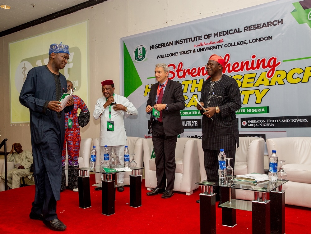 Hon Minister of Power Works  Housing and Chairman NIMR Research FoundationMr Babatunde FasholaSANleftDirector GeneralCEO Nigerian Institute of Medical ResearchProf Babatunde Lawal SalakorightHead International Operations Wellcome Trust United Kingdom Dr Simeon Kay2ndright and others during theNational Workshop on Strengthening Health Research Capacity organized by the Nigerian Institute of Medical Research NIMR at the Sheraton Hotels  Towers Abuja on Friday 7thSeptember 2018