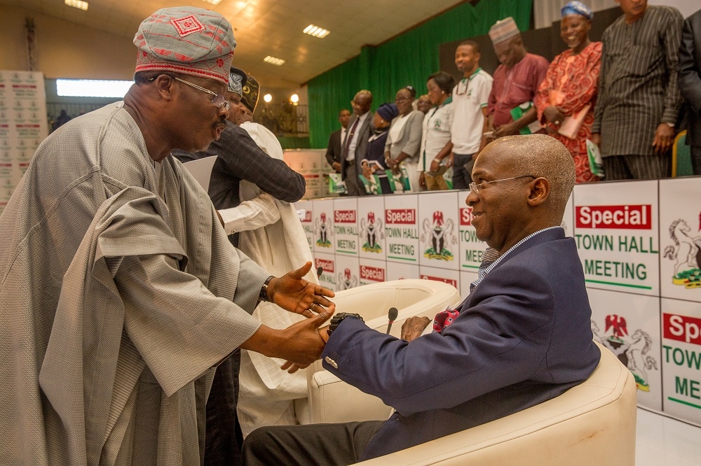 Hon Minister of Power Works  Housing Mr Babatunde Fashola SANright being welcomed by Governor of Oyo State Senator Abiola Ajimobi left duringthe Special Town Hall Meeting on Infrastructureat the Emeritus Professor Theophilus Ogunlesi Hall opposite UCH main gateQueen Elizabeth road Ibadan Oyo State on Thursday 25th October 2018