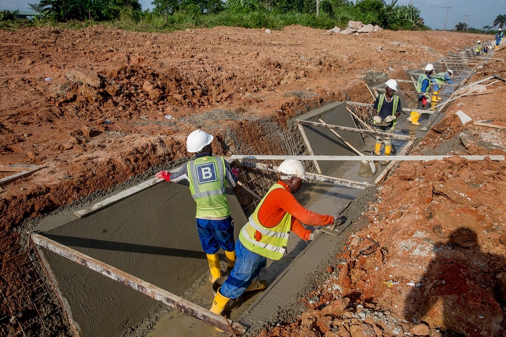 Personnel of Julius Bergerworking on the construction of the concrete lined drain at the Mowe area during an inspectionof the ongoing Rehabilitation Reconstruction and Expansion of theLagos Ibadan Expresswayby the HonMinister of Power Works  Housing Mr Babatunde Fashola SAN on Thursday 25th October 2018