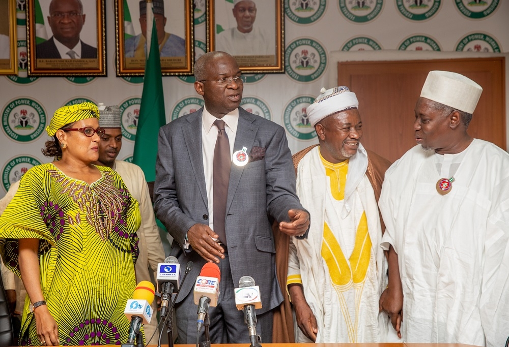 Hon Minister of Power  Works   Housing  Mr Babatunde Fashola  SAN 2nd left   Minister of State   Surveyor Suleiman Zarma Hassan   right   Village Head of Gora  Alhaji  Jafaru Adamu 2nd right  and  Farming Entrepreneur  Hajia Kareen Fatimah Mohammad   left  in a group photograph  shortly after a Courtesy Thank You Visit for the completion and deployment of 24 7 Solar Power in the Anguwan  Neighborhood Villages  of Gora Community in Karu Local Government Area of Nasarawa State by the Rural Electrification Agency  REA  as part of the Federal Government s  Rural Electrification Strategic Implementation Plan  at the Ministry of Power  Works   Housing Headquarters  Mabushi  Abuja on Tuesday  11th   December 2018