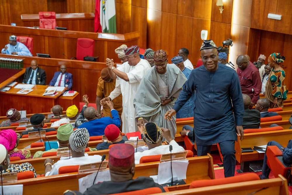 Former Hon  Minister of Power  Works   Housing  Mr Babatunde Fashola  SAN exchanges greetings with a Senator shortly after his Senate Confirmation Screening following his renomination by President Muhammadu Buhari as a Minister of the Federal Republic at the Senate Chamber  National Assembly on Monday 29th  July 2019