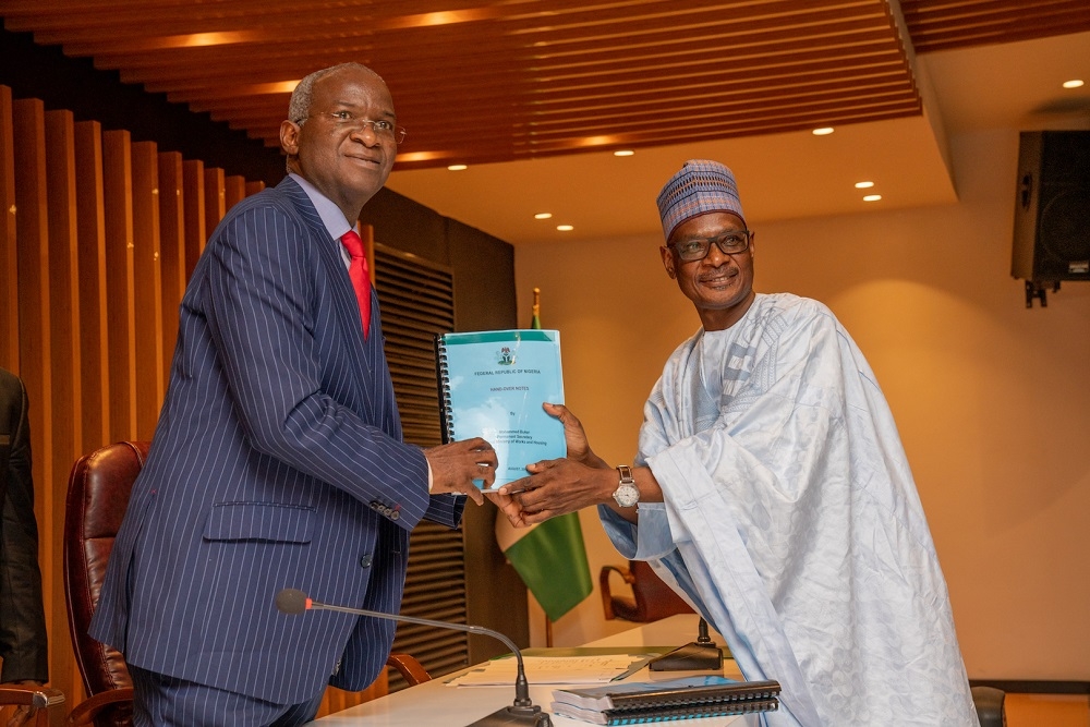 Hon  Minister of Works   Housing  Mr Babatunde Fashola SAN left  receiving the Handing Over Note from Permanent Secretary  Works   Housing  Mr  Mohammed Bukar right    during the resumption of duties at the Ministry by   the Minister after being sworn in at the Presidential Villa in Abuja on  Wednesday  21st August 2019