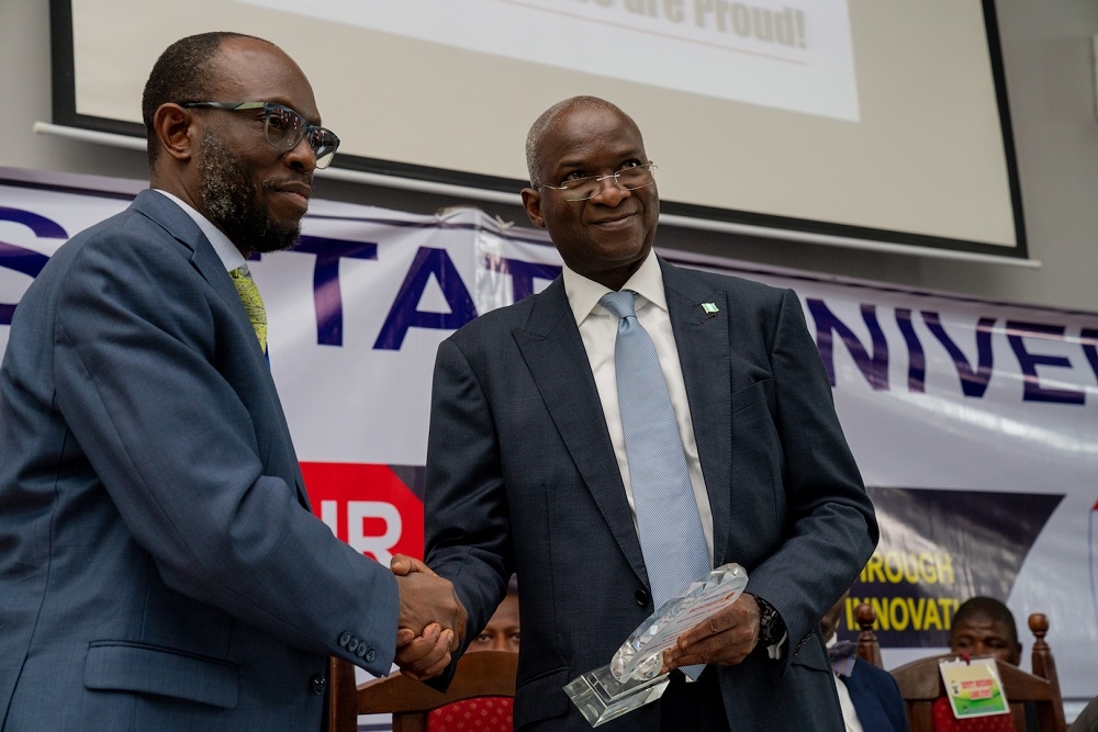 Hon  Minister of Works   Housing  Mr  Babatunde   Fashola SAN  right  being presented an appreciation plaque by Lagos State University s Vice Chancellor  Prof  Olanrewaju Fagbohun  SAN  shortly after the Hon  Minister delivered the Keynote Address at   the University s 1st   Research Fair and Endowment of Research Grants Fund with the theme   Driving National Development through Research and Innovation   at the Aderemi Makanjuola Lecture Theatre  LASU  Ojo  Lagos on Tuesday 3rd  September 2019