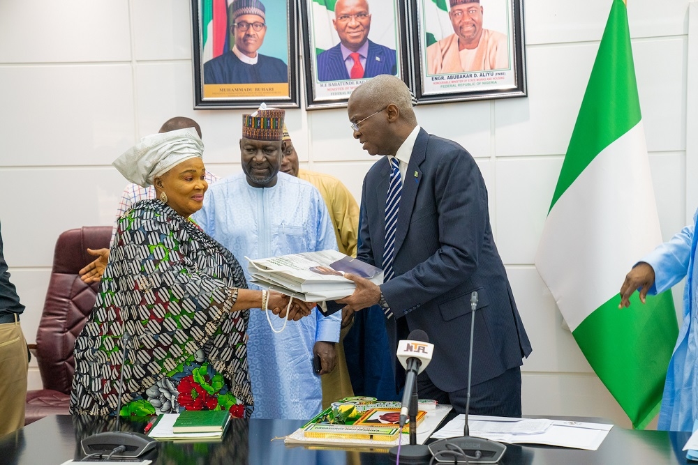 Hon  Minister of Works   Housing  Mr Babatunde Fashola SAN right   flanked by  Minister of State in the Ministry  Engr  Abubakar Aliyu  middle  while  presenting copies of the Book   Proof of Infrastructure Delivery Across Nigeria   to South West Coordinator Good Governance Ambassadors of Nigeria GOGAN    Alhaja Bisi Eletu left   shortly after a courtesy visit by the GOGAN at the Ministry of Works   Housing  Headquarters on Thursday  12th September  2019