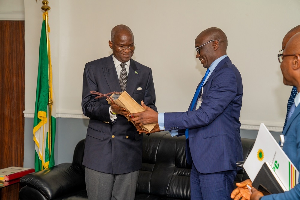 Hon  Minister of Works   Housing  Mr Babatunde Fashola SAN  left  presenting copies of publications on the Ministry s activities to the Group Managing Director  Nigerian National Petroleum Corporation  NNPC   Mr Mele Kolo Kyari  right  during a courtesy visit and meeting to discuss issues relating to improvement of service delivery to citizens at the Minister s Office  Ministry of Works   Housing Headquarters  Mabushi  Abuja on Monday   23rd September 2019