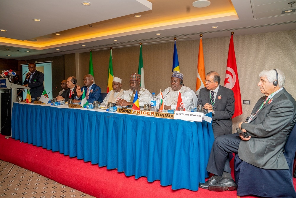 Representative of His Excellency  President Muhammadu Buhari and Hon  Minister of Police Affairs  Alhaji Mohammed Dingyadi  4th left  Hon  Minister of Works   Housing  Mr Babatunde Fashola SAN 3rd left   Minister of State in the Ministry  Engr  Abubakar Aliyu  4th right   Secretary General  Trans Saharan Road Liasion Committee  Mr Mohammed Ayadi right    the Malian Ambassador to Nigeria  Ambassador Mahamane Amadou Maiga  left     Hon Minister of Public Works  Peoples Democratic Republic of Algeria  Mr Mustapha Kouraba  2nd left   Hon  Minister of Public Works  Republic of Niger  Mr Kadi Abdoulay  3rd right   and Hon  Minister of Public Works Mr Noureddine Selmi  2nd right   during the Opening Ceremony of the 70th Session of the Trans Saharan Road Liaison  Committee  TRLC  hosted by the Federal Ministry of Works   Housing at the Transcorp Hilton Hotel Abuja on Monday  11th November 2019 