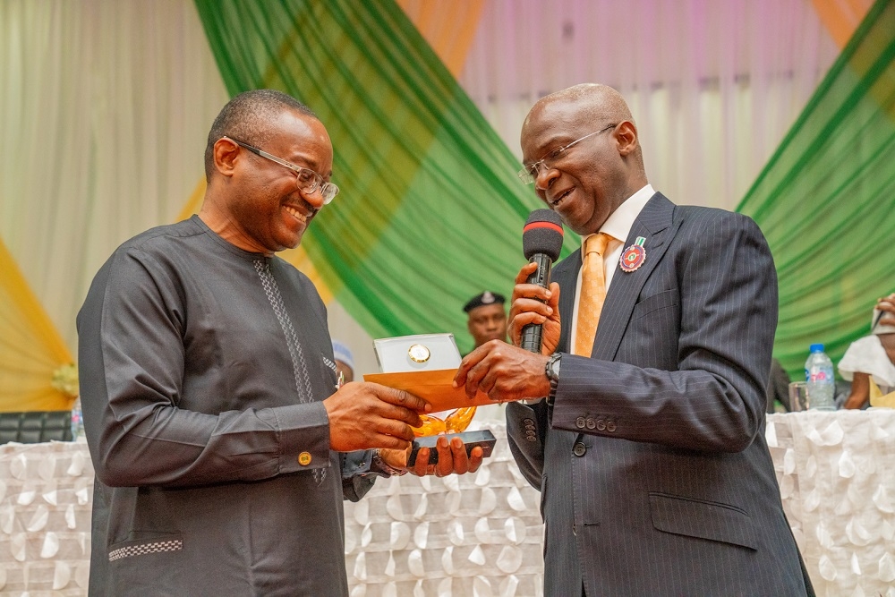 Hon  Minister of Works   Housing  Mr Babatunde Fashola SAN right  presenting the Most Outstanding Director of the Year to      Director   Highways Planning and Development  Engr  Chukwunwike Ogbonna Uzo   left  during   the Federal Ministry of Works   Housing 2018 Recognition   Reward Ceremony at the Idris  A  Abdulkadir Auditorium National Universities Commission Maitama  Abuja