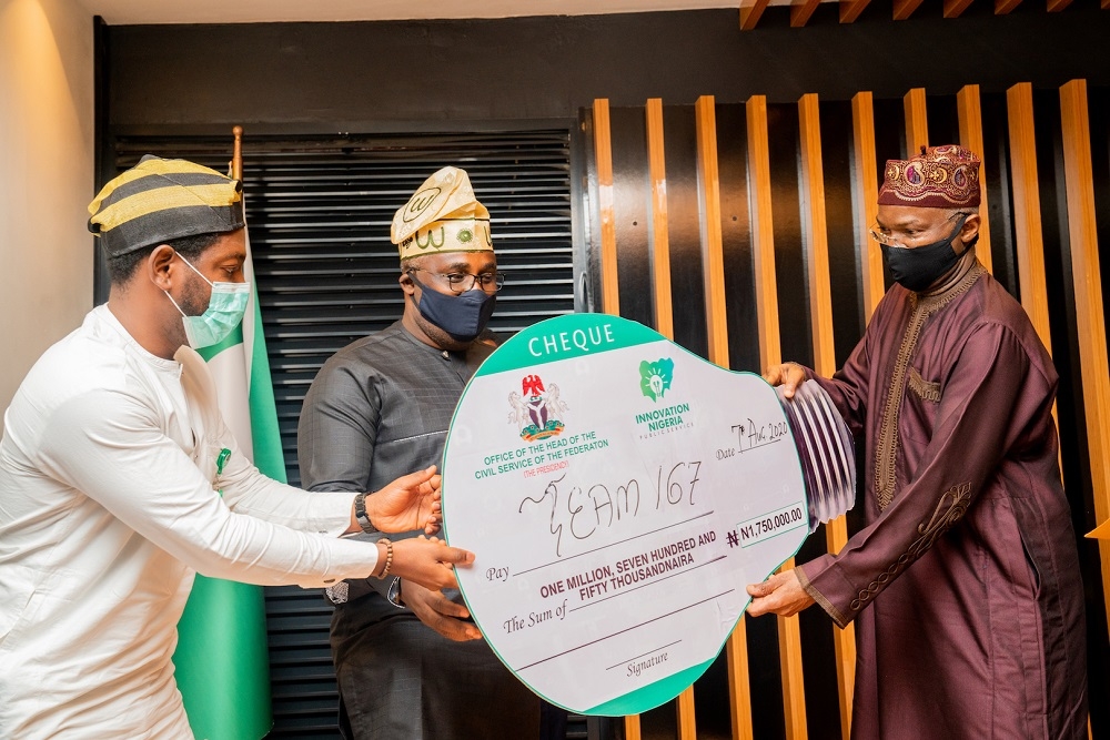 Hon. Minister of Works and Housing, Mr Babatunde Fashola,SAN(right) presenting an Award to the 2ndÂ runner-up, Team 167, Mr Winsala Oluwaseun(middle) and Mr Ebire Francis (left) duringÂ Â the Award Ceremony of the Maiden Edition of the Federal Civil Service Innovation Competition 2020-Â organized by the Office of the Head of the Civil Service of the Federation at the Ministry of Works and Housing Conference Hall, Mabushi, Abuja on Friday,7th August 2020