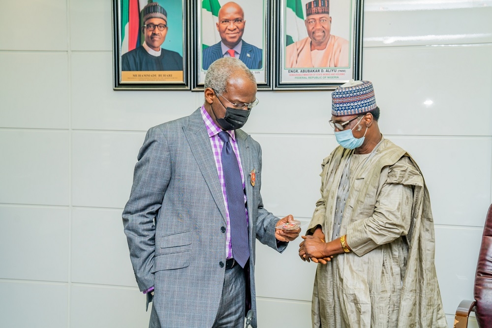 Hon. Minister of Works and Housing, Mr Babatunde Fashola,SAN (left) shortly after being decorated with the Armed Forces Remembrance Day Celebration Emblem 2021 by the National Chairman of the Nigerian Legion, Brig. General Adakole Jones Akpa (Rtd) at the Ministry of Works and Housing Headquarters, Mabushi, Abuja on Tuesday, 17th November  2020