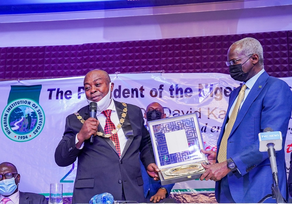 Hon. Minister of Works and Housing, Mr Babatunde Fashola, SAN (left) being presented a plaque by the President, Nigerian Institution of Surveyors, Surveyor Kayode Oluwamotemi during the 39th Annual Olumide Memorial Lecture organized by the Nigerian Institution of Surveyors (NIS) and delivered by the Hon. Minister on the theme, &quot; Human Capital and Institution Building,&quot; at the Chida International Hotel, Utako, Abuja on Thursday 14th October 2021. 