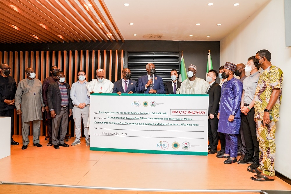 Hon.Minister of Works and Housing, Mr. Babatunde Fashola,SAN (middle), Executive Chairman, Federal Inland Revenue Service (FIRS), Mr. Muhammad Nami (6th left),  Representative of the Group Managing Director/ Chief Finance Officer of the Nigerian National Petroleum Corporation,Mr Umar Ajiya (5th left), Permanent Secretary in the Ministry of Works and Housing, Mr Babangida Hussaini (5th right), Project Manager, Salini Nigeria Ltd,Mr Gennaro D&#039;itria (4th left), Managing Director, KAU International Ltd, Mr Ibrahim Babasheu  (3rd right), Head of Roads and Infrastructure, RCC (Nig.) Ltd, Mr Feda Natour (6th right) and Deputy Managing Director, CCECC , Mr Jacques Liao (4th right) during the Symbolic Cheque Presentation for 21 Critical Roads funded by the NNPC through the Road Infrastructure Tax Credit Scheme at the Conference Room of the Ministry of Works and Housing Headquarters, Mabushi, Abuja on Tuesday, 21st December 2021.