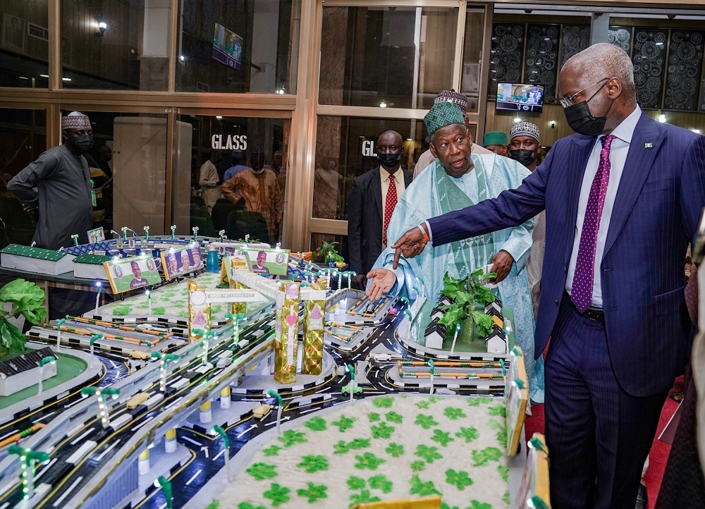 Hon. Minister of Works and Housing, Mr. Babatunde Fashola, SAN (right) and  Governor of Kano State, Dr. Abdullahi Umar Ganduje(left) inspecting a model of the State&#039;s proposed three weighbridges at the three major entrances to the State during a courtesy visit to the Kano State Government House as part of a Federal Government Projects inspection visit  on Wednesday, 26th January 2022.