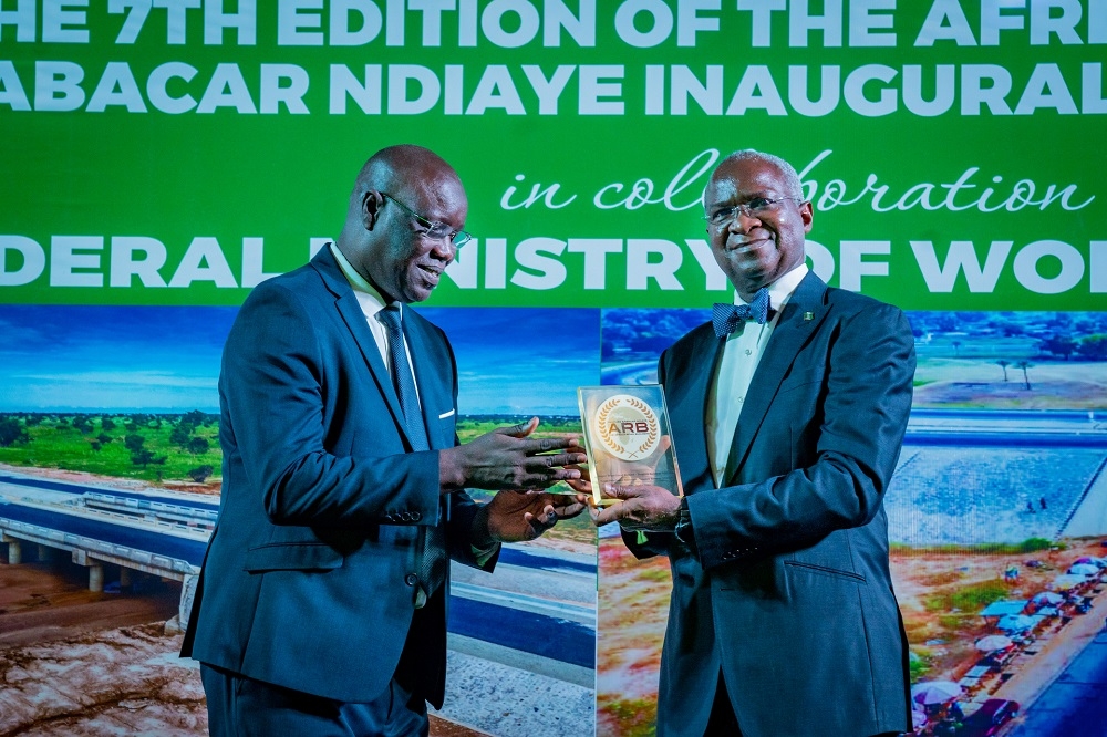 PRESIDENT BUHARI WINS AFRICA ROAD BUILDERS AWARD...Representative of President Muhammadu Buhari and Hon. Minister of Works &amp; Housing, Mr Babatunde Fashola,SAN (right) being presented the Super Prize Global Trophy of the Africa Road Builders - Trophee Babacar Ndiaye on behalf of His Excellency, President Muhammadu Buhari by a former Ambassador from Senegal, Moustapha Dieye (left)  at the Inaugural Conference Dinner for the 7th Edition of the Africa Road Builders - Trophee Babacar Ndiaye  Conference with the theme,&quot; Building Roads, Building Economies&quot;at  the Transcorp Hilton Hotel , Abuja on Thursday 31st March 2022. 