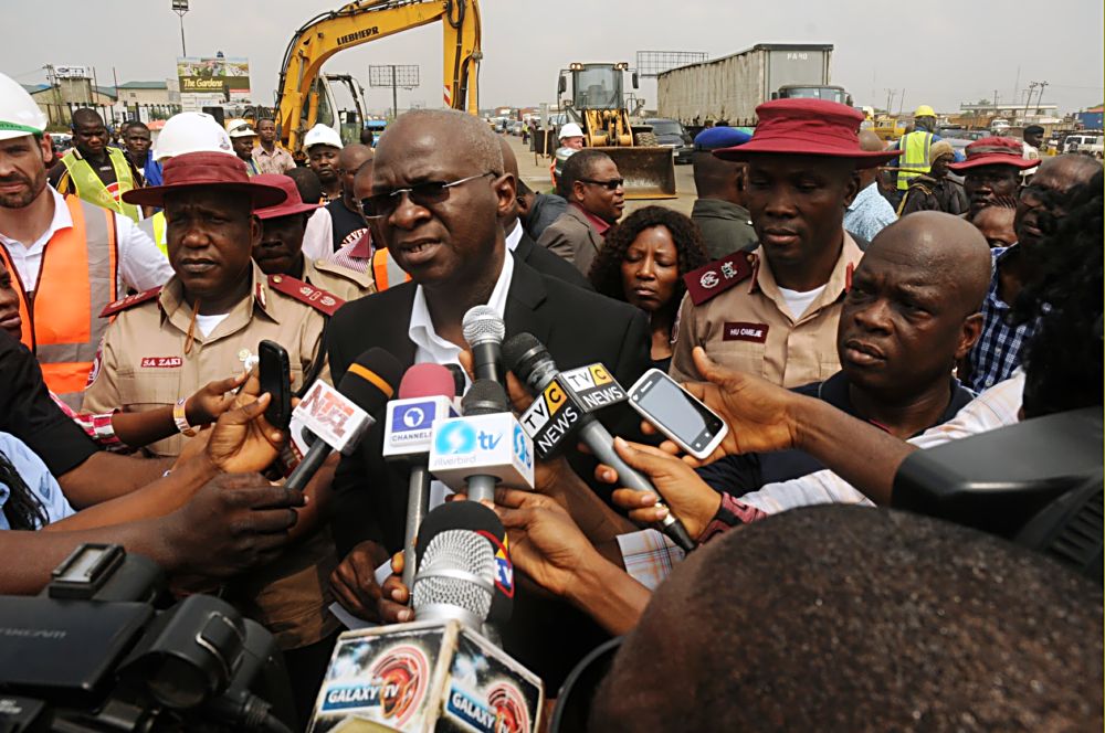 Hon. Minister of Power, Works and Housing, Mr Babatunde Fashola, SAN (middle) flanked by the Zonal Commanding Officer for RSZ of the Federal Road Safety Corps (FRSC), Assistant Corps Marshal Shehu Zaki (2nd left), Lagos State Sector Commander of the FRSC, Mr Hyginus Umeje (2nd right) and Commercial Manager of Julius Berger Nigeria Plc, Mr Hans Meletschus (left) while addressing media men shortly after inspecting the completed Phase One of the rehabilitation of the Long Bridge after 40 years of use as part of the reconstruction and rehabilitation of the Lagos-Ibadan Expressway by the Federal Government on Monday 12th December, 2016