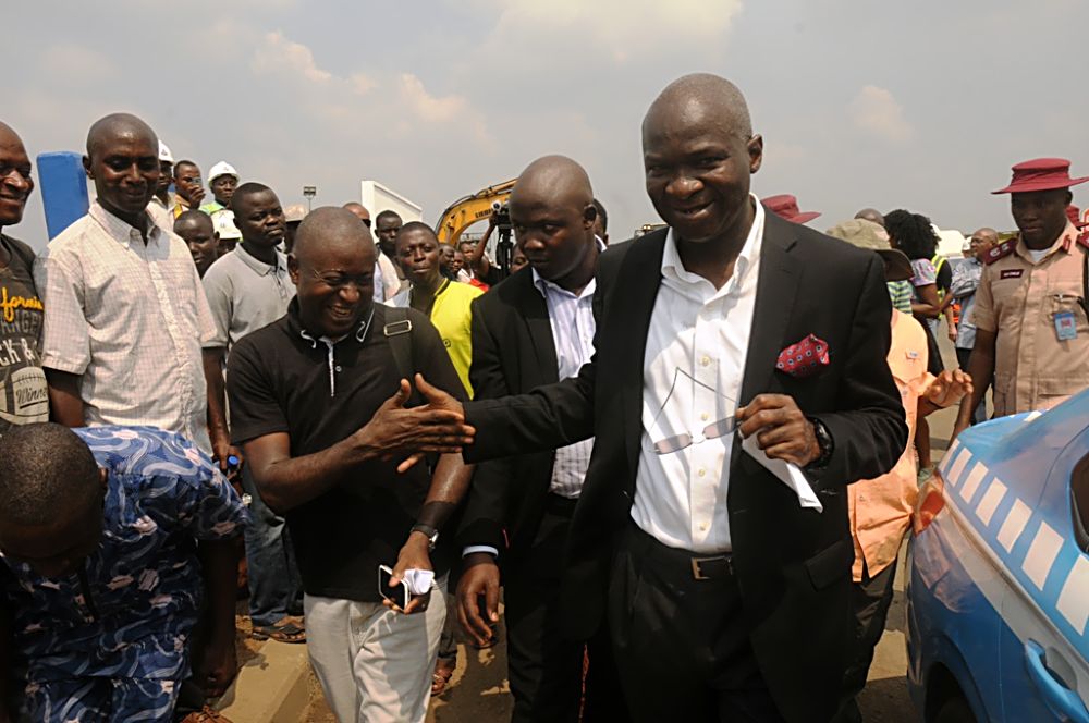 Hon. Minister of Power, Works and Housing, Mr Babatunde Fashola, SAN (right) being congratulated by a journalist and resident of one of the adjoining communities, Mr Kelvin Okunbor   (left) and others shortly after the Ministerâ€™s inspection of the completed Phase One of the rehabilitation of the Long Bridge after 40 years of use as part of the reconstruction and rehabilitation of the Lagos-Ibadan Expressway by the Federal Government on Monday 12th December, 2016