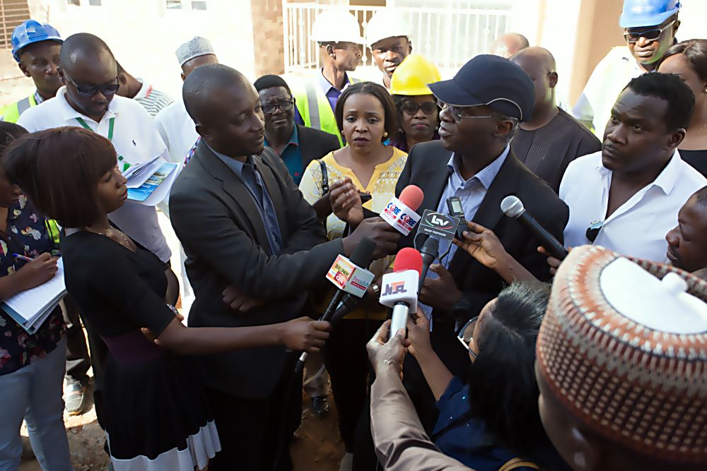 Hon.Minister of Power, Works & Housing, Mr Babatunde Fashola, SAN (middle) flanked by Managing Director, Lechase Morgan Nigeria Limited, Mrs Lola Otegbola(left)and Managing Director, Netconstruct Nigeria Limited, Mr Afolabi Oseni(right) as he speaks with  journalists shortly after inspecting  Sunny Vale Homes in Apo and other Housing Development Companies in Abuja on Thursday 1st December , 2016. 