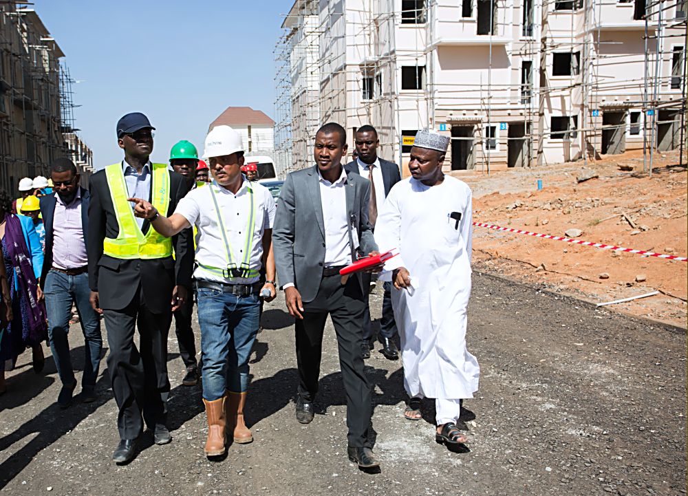 Hon.Minister of Power, Works & Housing, Mr Babatunde Fashola, SAN (left), Director in the Ministry, Arch. Gidado Sani(right), Manager Technical Operations, Brains & Hammers Limited, Engr. Madhur Tripathi (2nd left) and others during the Minister's inspection tour of the Brains & Hammers Estate, Gwarimpa, Life Camp, Abuja on Thursday 1st December 2016. 